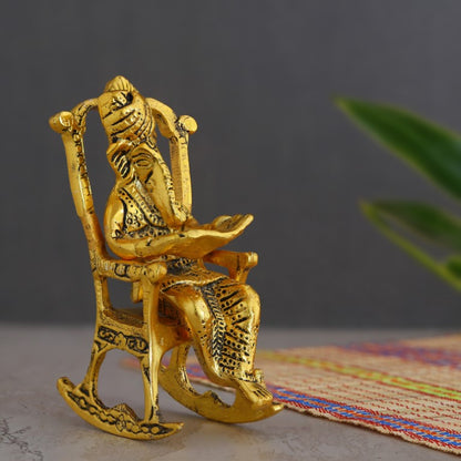 Lord Ganesha Idol Reading Book on Rocking Chair